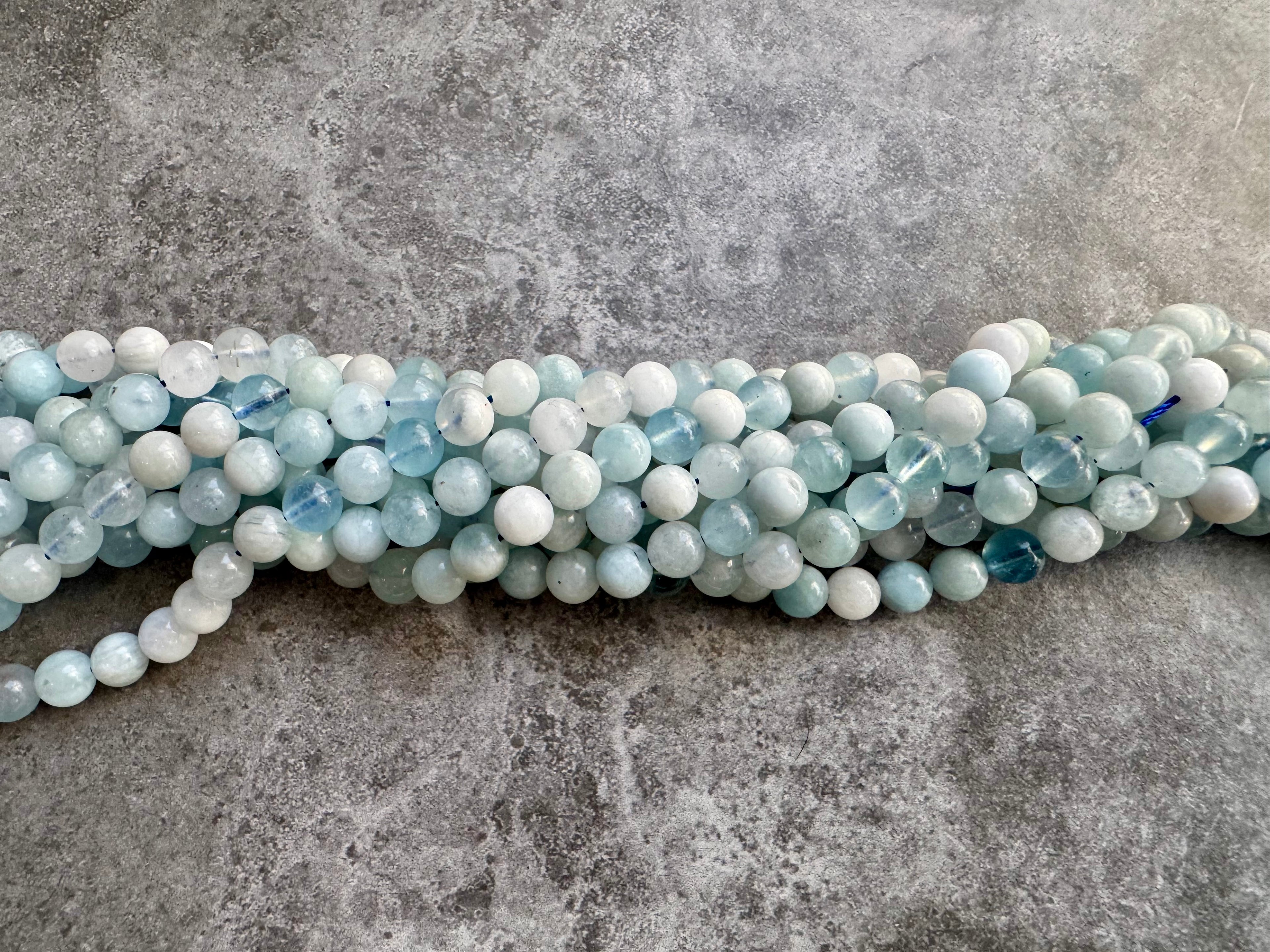 Multiple strands of 6mm mixed colour aquamarine 